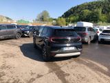 a lot of cars parked in a parking lot with mountains in the background