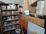 a room with a lot of boxes on the shelves