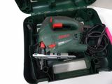 a green box with a tool in it on a table
