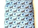 blue and black patterned tie laying on a white surface