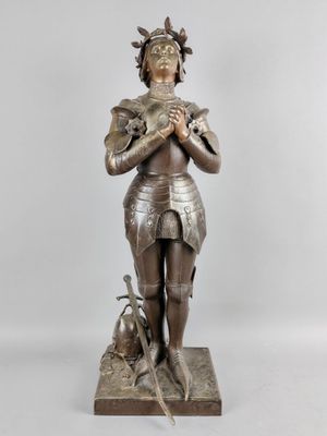 an image of a statue of a woman holding a dog