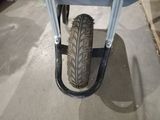 a wheelbarrow with a tire attached to it in a garage