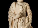 statue of a man with a beard and a robe on a black background