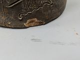 a metal container that has a skull and crossbone on it