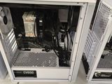 three white computer cases sitting on top of a white table