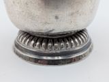 a silver bowl sitting on top of a metal stand