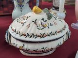 a large white bowl with a lid on a table
