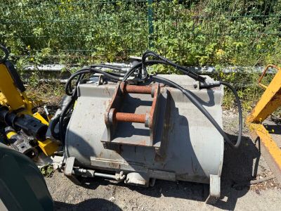 a machine that is sitting on the ground next to a tree