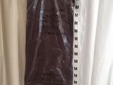 a plastic bag hanging on a shower curtain with a measuring tape