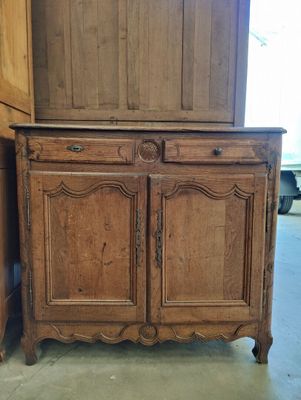 an old wooden cabinet with two doors and a drawer on top of it