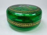 a green glass box with a gold design on it
