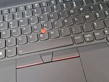 a black laptop with a red button on the keyboard