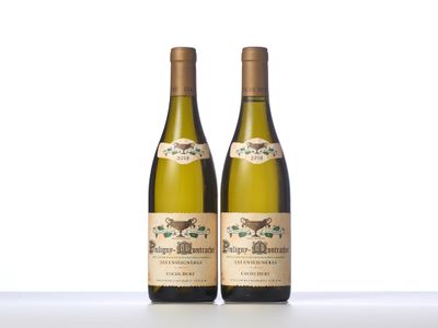 two bottles of white wine sitting on top of a table