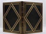 a black and gold book with gold trims on it