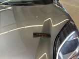 a sticker on the hood of a silver car