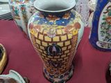 many vases and plates on a table with a red table cloth