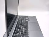 a silver laptop with a black keyboard on a white surface