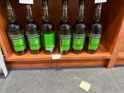 des bouteilles d'huile d'olive sur une étagère dans une épicerie
