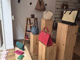 a room with a lot of handbags and bags on the floor