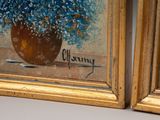 two paintings of blue flowers in a vase on a table