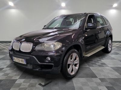 une photo d'un SUV bmw noir garé dans un garage