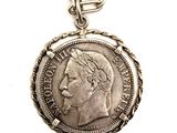 an image of a silver coin with a chain on a white background