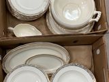 a lot of white plates and bowls in a box