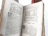 someone is holding an open book with a picture of a man on it