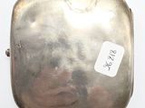 a small silver box with a sticker on it