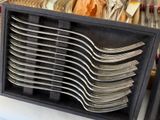 a lot of forks and spoons in a black box