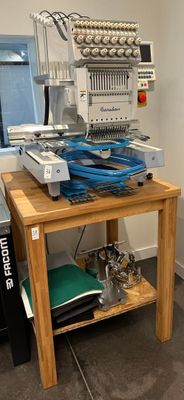 a small table with a bunch of sewing machines on it