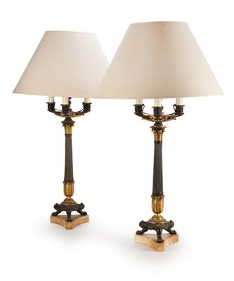 pair of brass and black table lamps with white lampshads