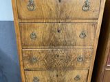 two wooden dressers and a chest of drawers in a room
