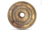 a gold plate with a circular design on it