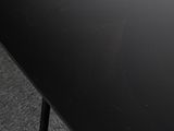 a close up of a black table with a black base