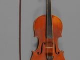 un violon posé à côté d'un archet