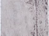 a black and white photo of a person walking on a beach