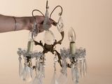 a person holding a crystal chandelier in their hand