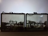 two framed pictures of a bridge and a building