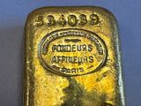 an image of a gold bar on a blue surface