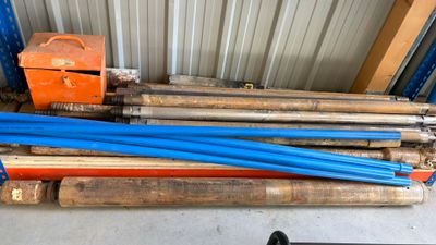 a pile of blue pipes sitting on top of a pallet