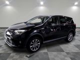 the black toyota rav is parked in a large room