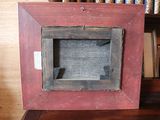 a picture of a picture frame on a table with books in the background
