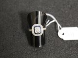 a ring with a diamond and a blue sapphire on it