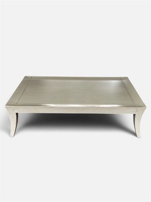 a white coffee table with a metal tray on top of it