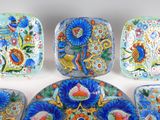 several plates with different designs on them sitting on a white surface
