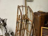 a pile of old skis and ski poles in a room