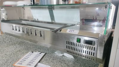 stainless steel counter top with a glass display case and menus