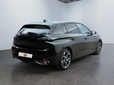 the rear end of a black car in a white room