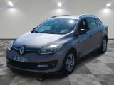 the grey car is parked on a checkered floor in a room